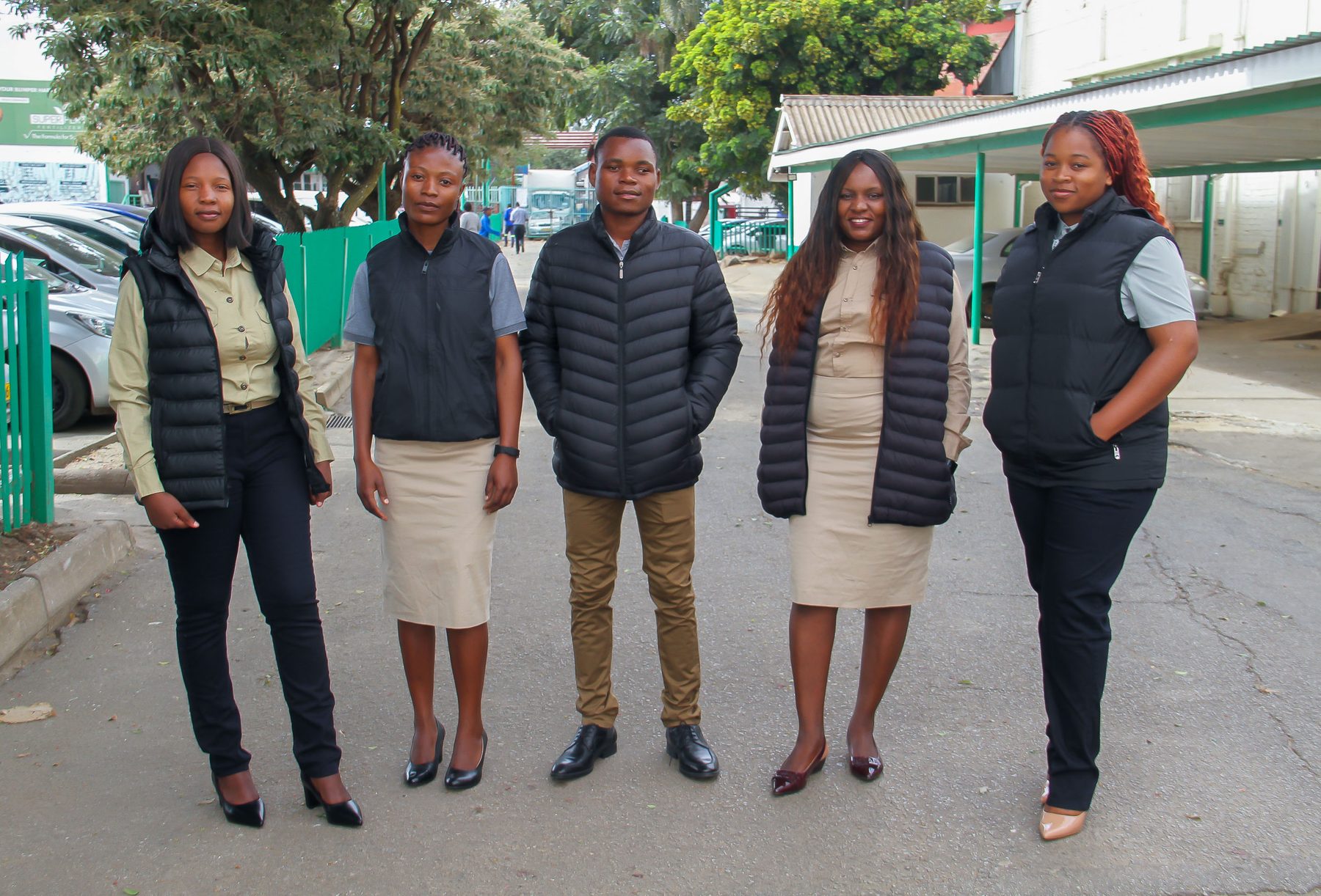 Team wearing branded puffer vests and business casual field wear