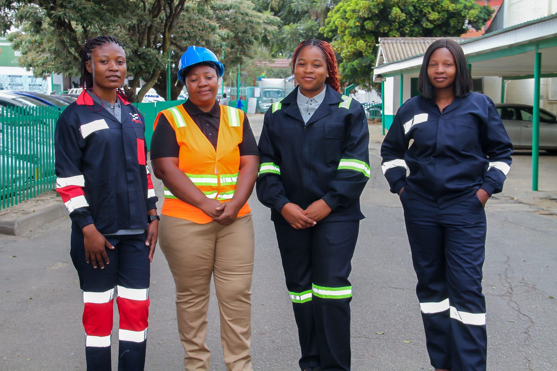 Workers wearing NECST industrial workwear coveralls and a hi-visibility vest